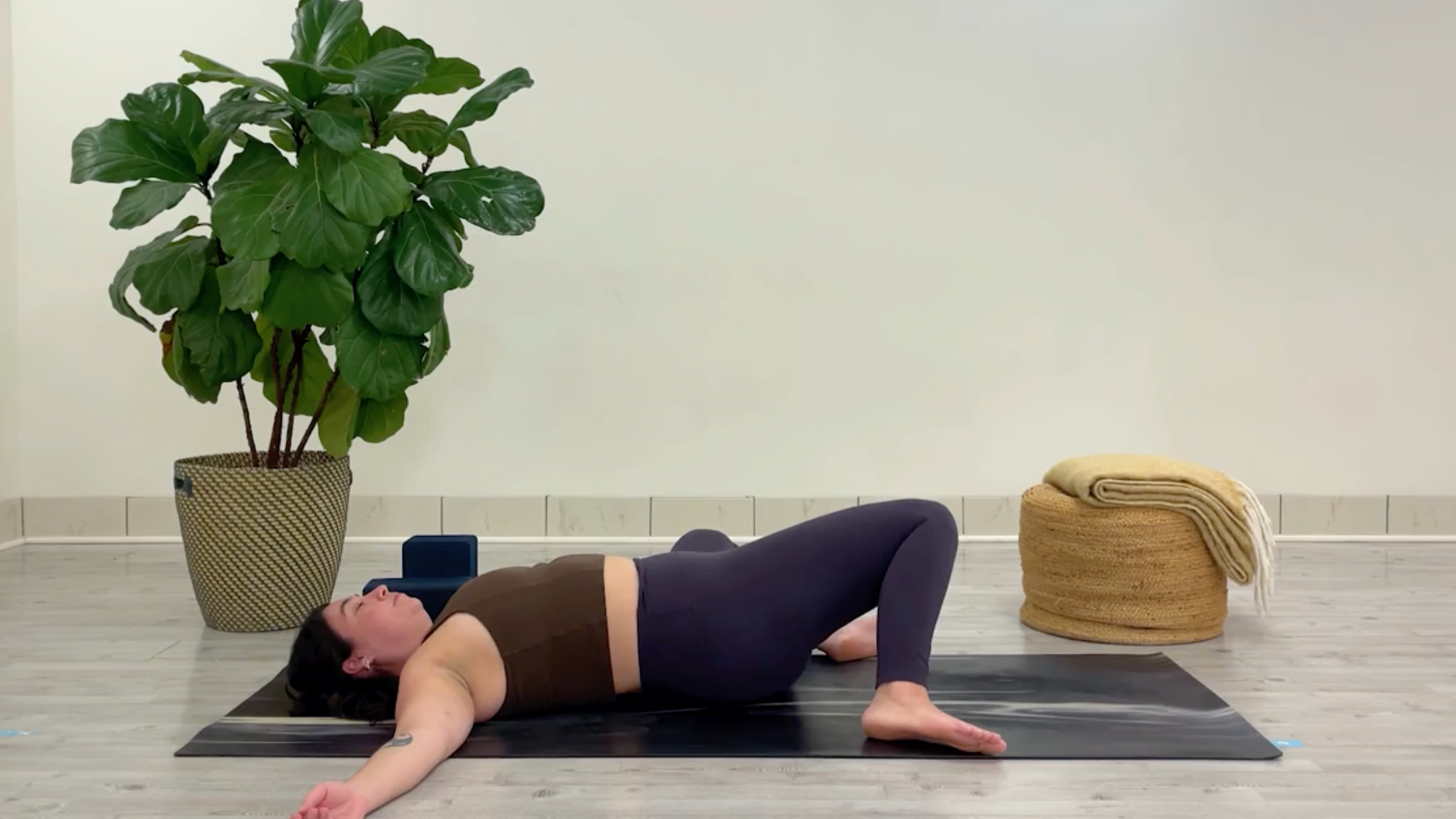 Yoga teacher Taylor Lorenz in Windshield Wipers, one of the best yoga poses for chilling out